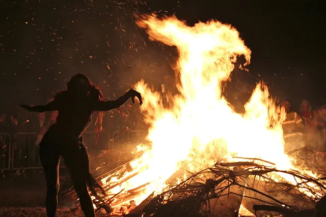 A silhouetted performer dances before the bonfire during the Beltane Fire Festival on Calton Hill, Edinburgh.