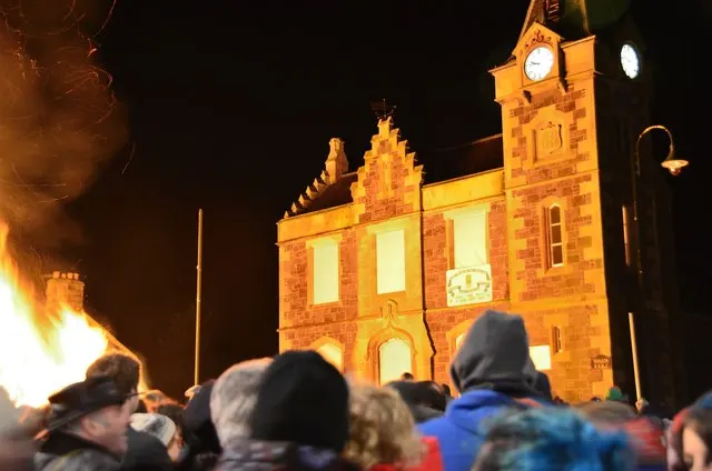 A bonfire blazes in front of the ornate Corn Exchange building as a crowd looks on in Biggar on Hogmanay night.