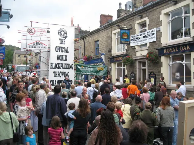 A crowd gathers outside the Royal Oak in Ramsbottom beneath the banner for the World Black Pudding Throwing Championship.