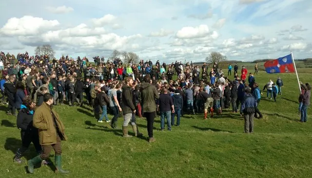 A dense crowd scrums together in a field during the bottle-kicking contest between Hallaton and Medbourne.