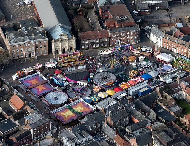 An aerial view over rides and stalls filling King's Lynn's Tuesday Market Place for the Mart funfair.
