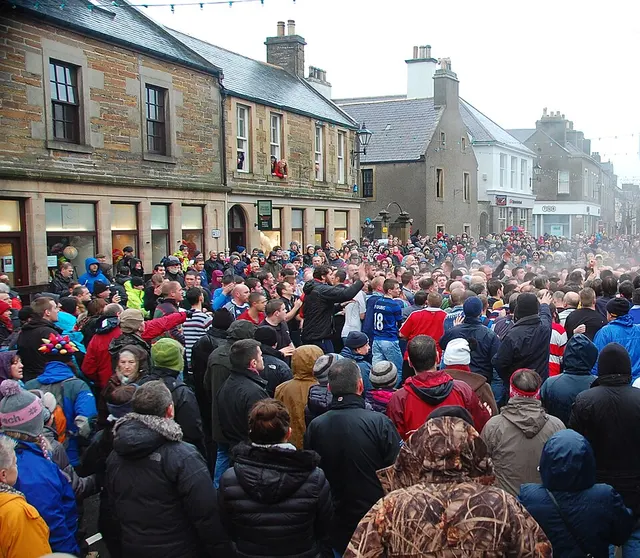 A dense crowd wrestles for the ba' in a scrum that fills Broad Street, Kirkwall, during the New Year's Day Men's game.