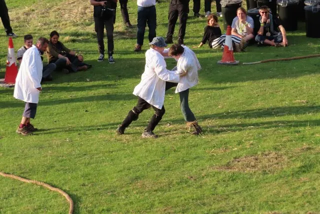 Two competitors grip each other's shoulders and try to kick out each other's shins during the shin-kicking contest at Robert Dover's Cotswold Olimpick Games.