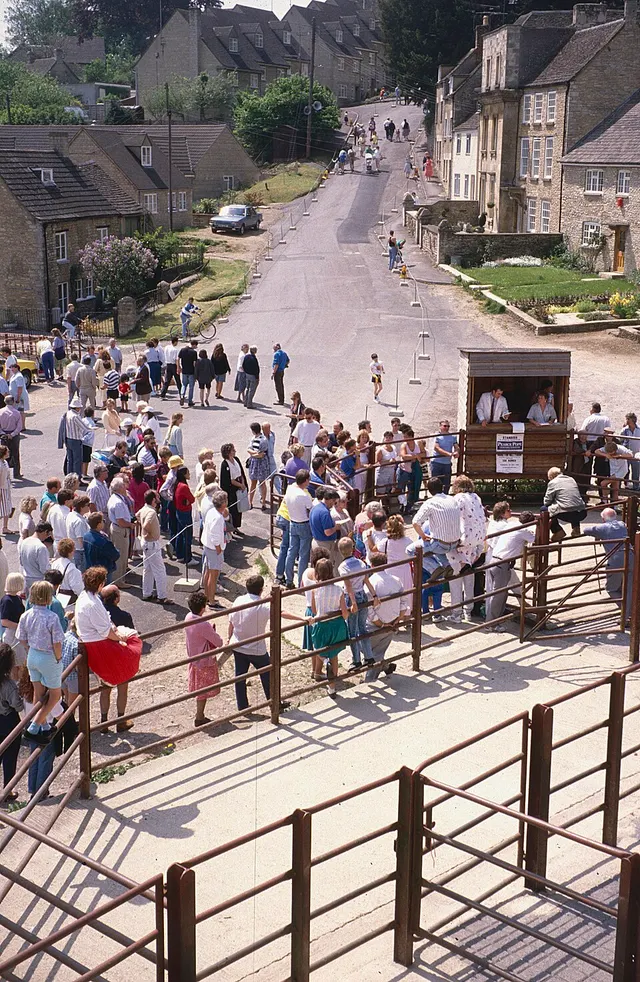 Spectators line the barriers at the base of Gumstool Hill on the day of Tetbury's Woolsack Race.