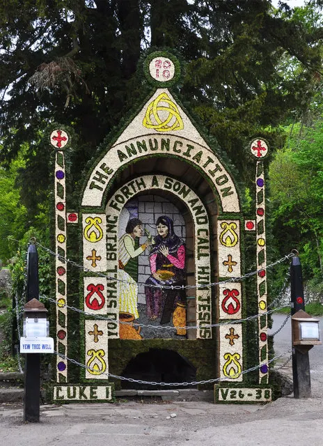 A completed well dressing depicting the Annunciation, made from flower petals and seeds, decorates Yew Tree Well in Tissington.