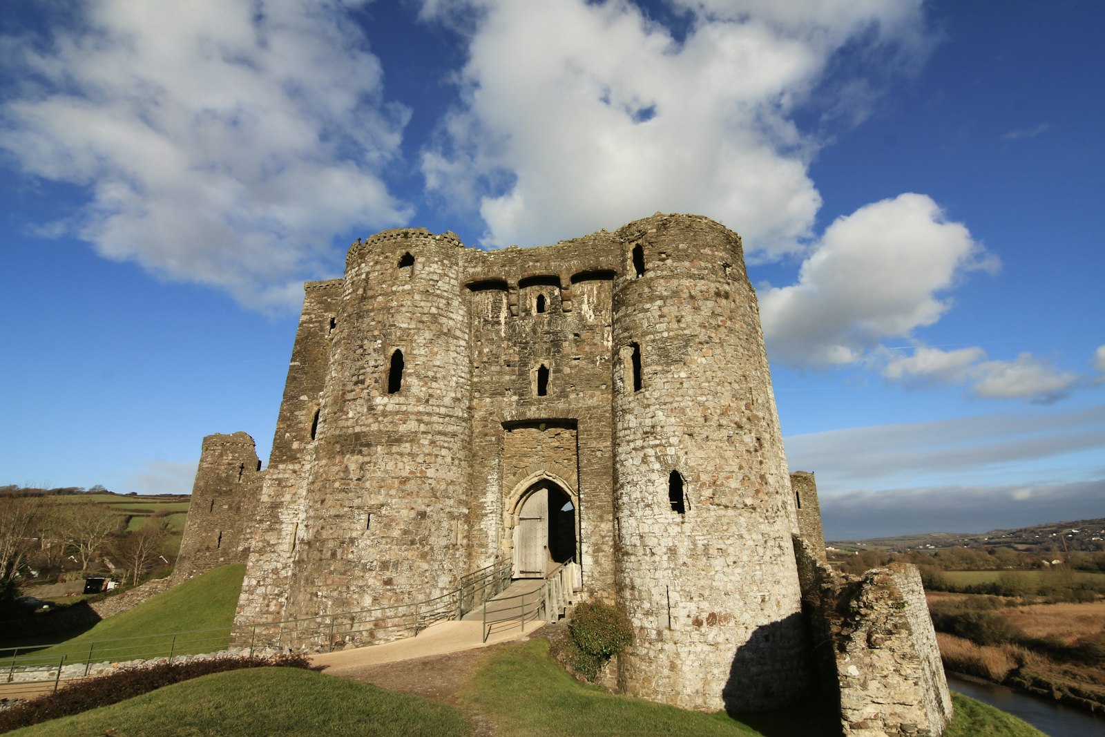 Photo of a castle with a walkway leading up to it.