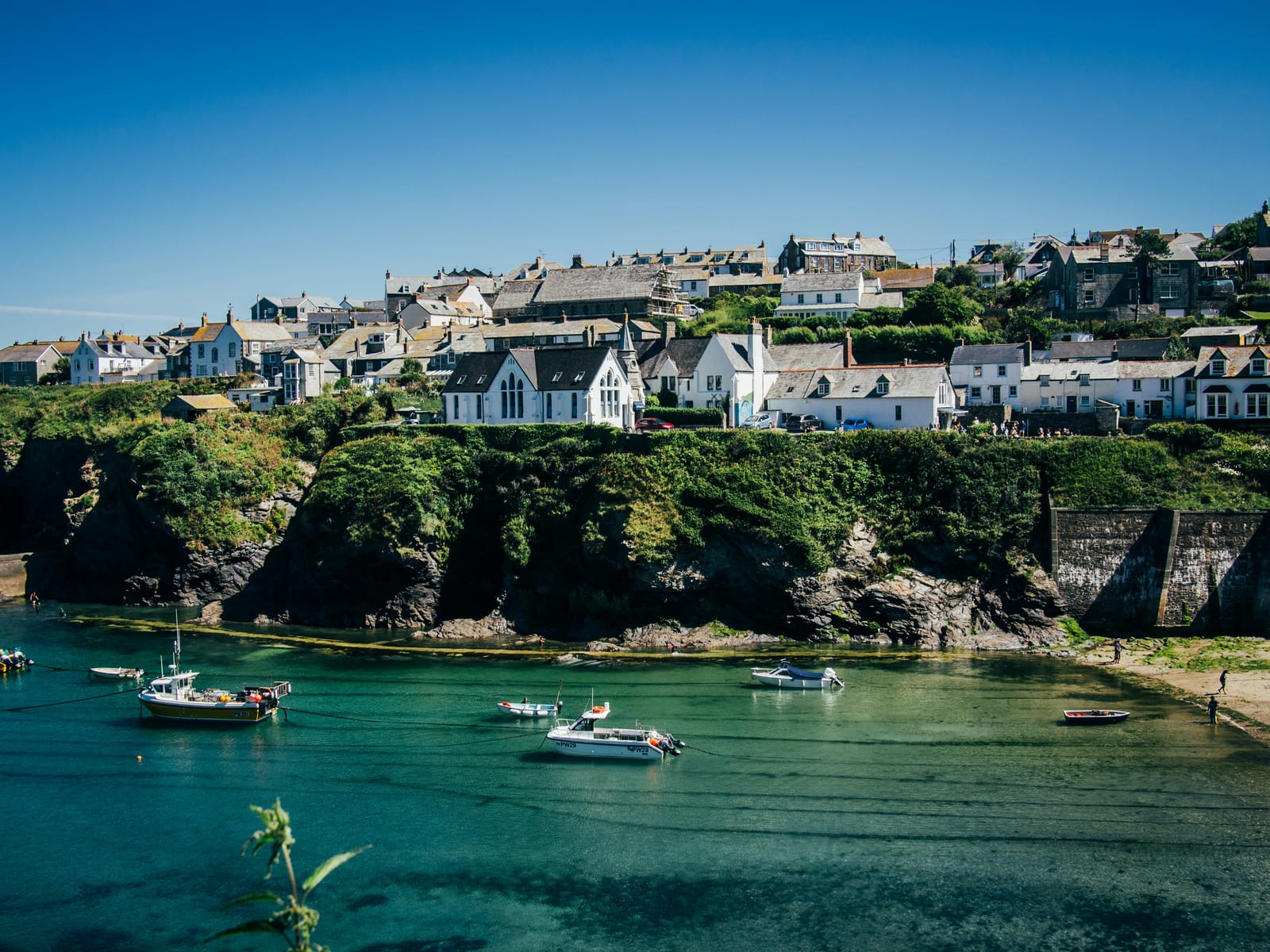Photo of the sunlit harbour at Port Isaac, Cornwall.