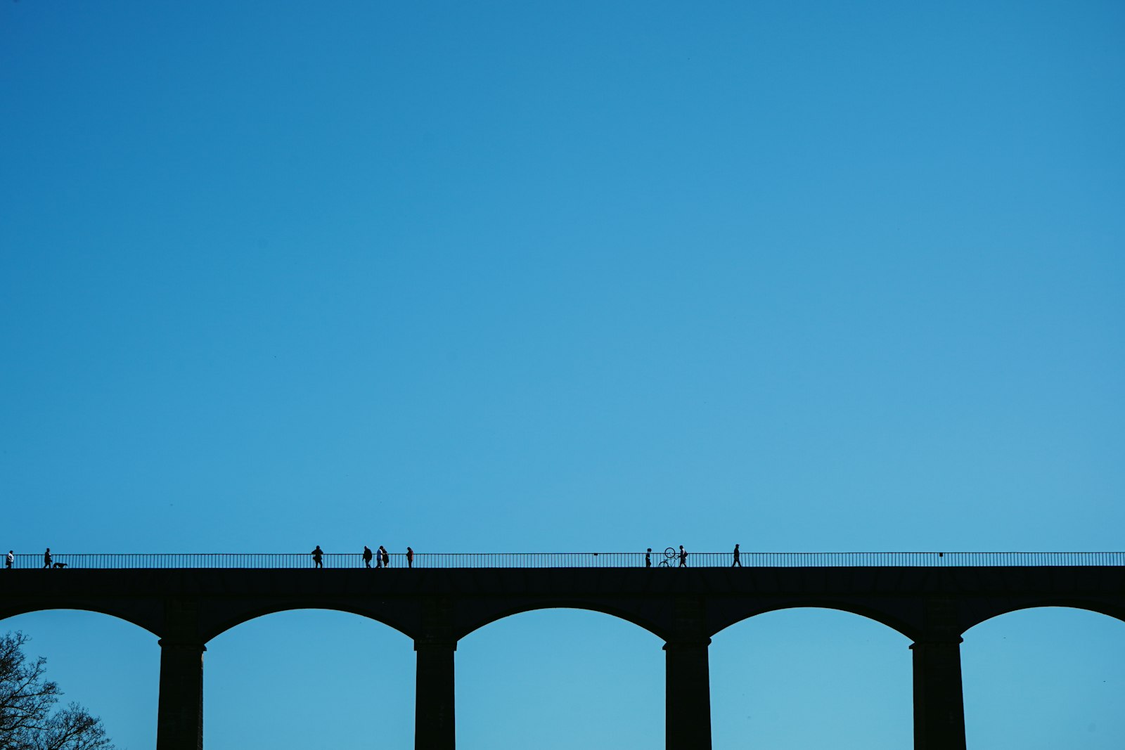 Photo of gray concrete bridge under blue sky during daytime.