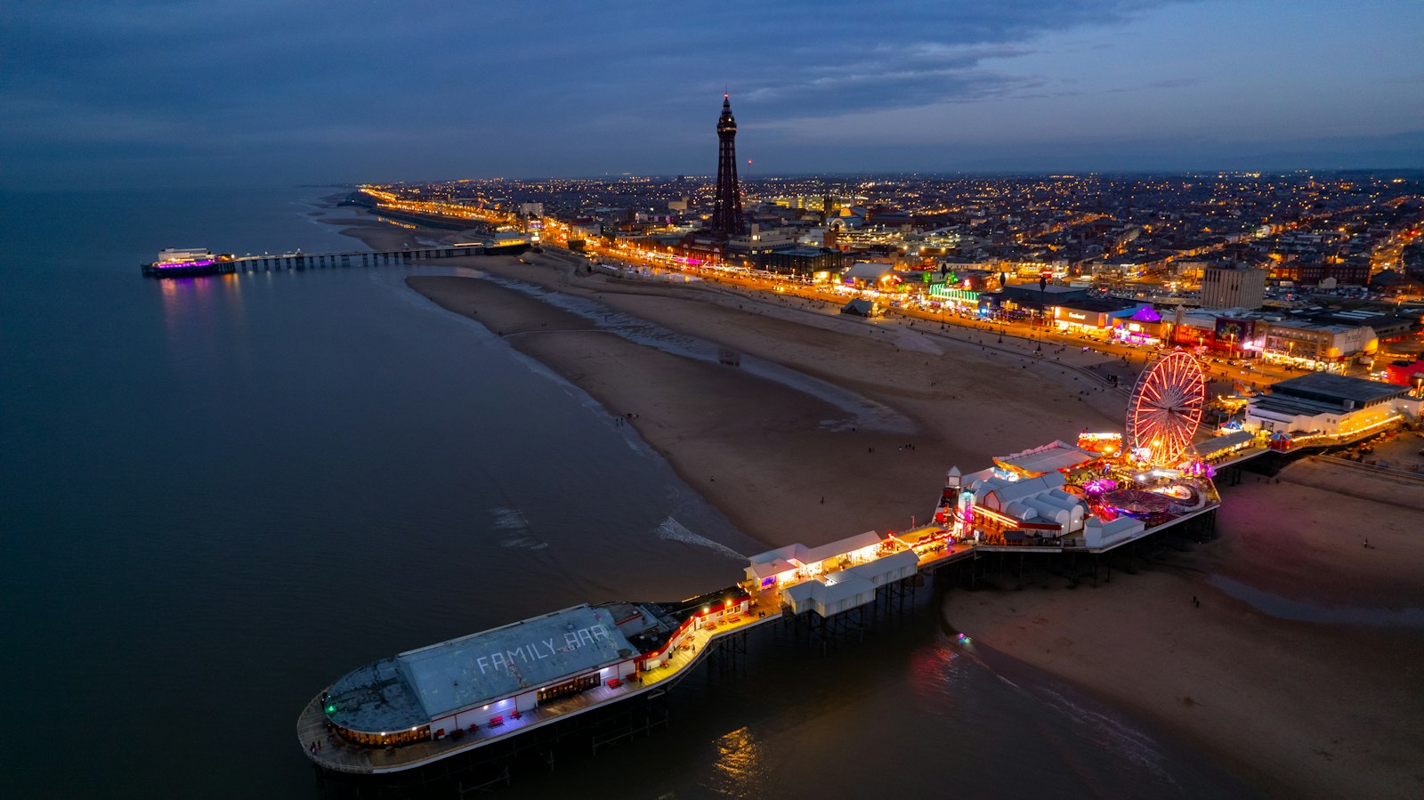Photo of an aerial view of a pier at night.