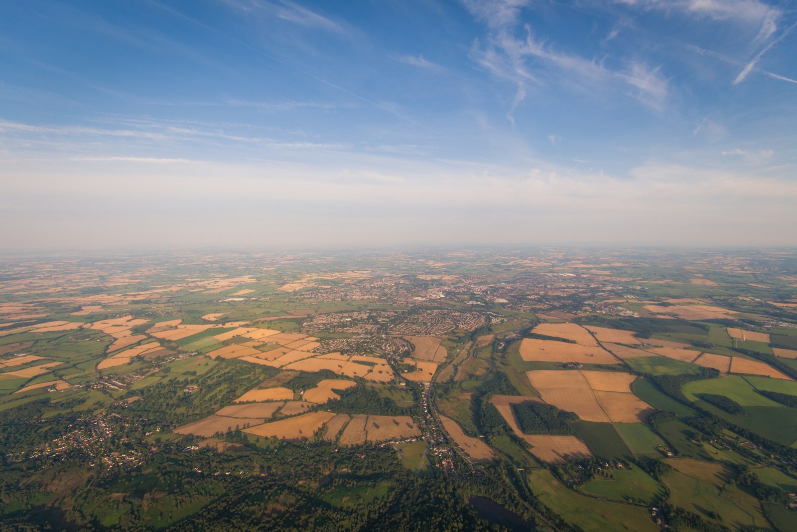 Photo of aerial photo of brown and green fields under blue sky during daytime.