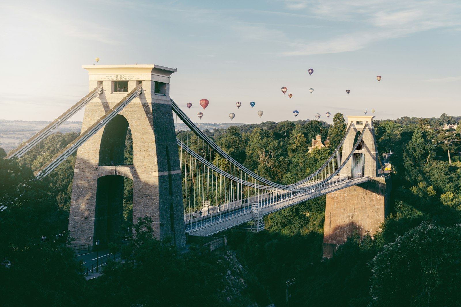 Photo of hot air balloons flying above trees.