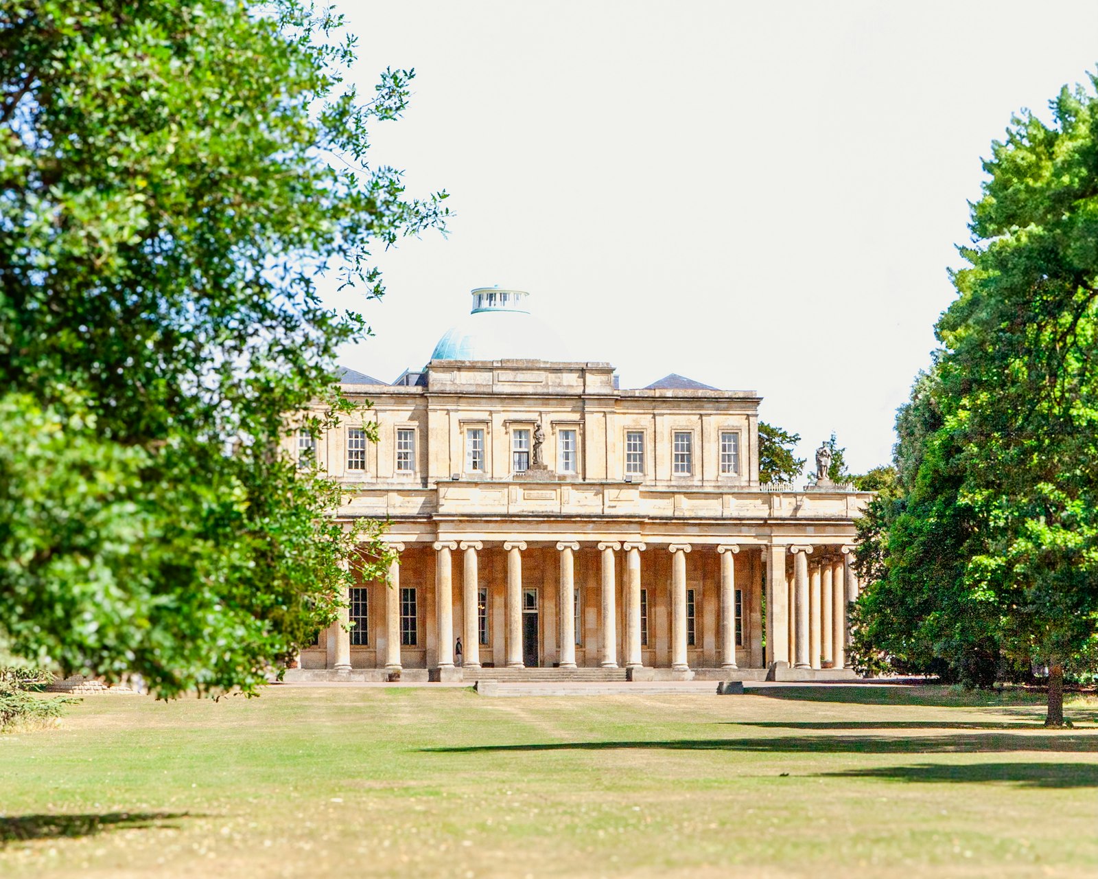 Photo of a large building with columns sits outside.